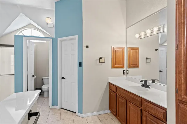 a bathroom with a double vanity sink mirror and shower