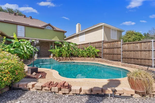a view of a backyard with a tub and chairs