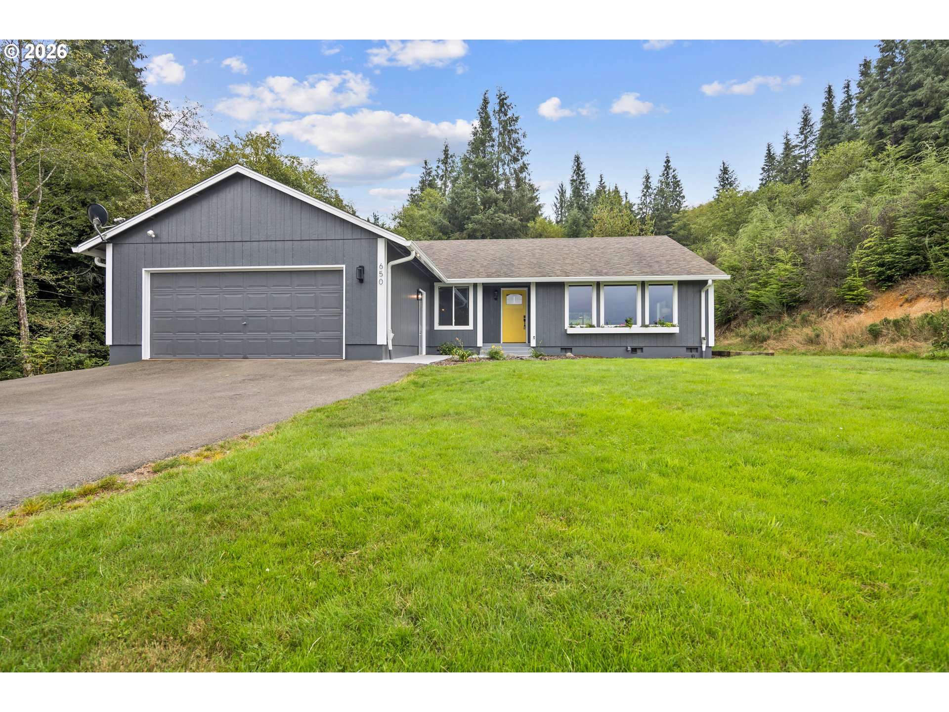 650 Marvin Road Tillamook, OR 97141 - Photo 1 of 48 a view of a house with yard and a garden