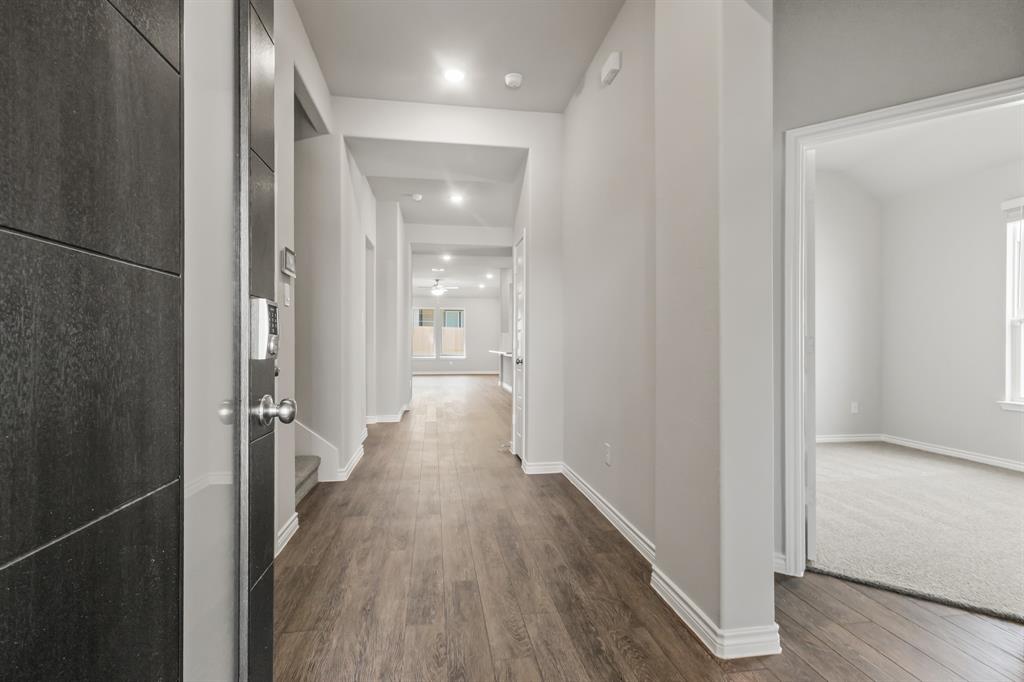 6909 Cattle Car Way Crowley, TX 76036 - Photo 2 of 24 a view of a hallway with wooden floor