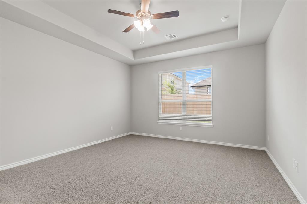 6909 Cattle Car Way Crowley, TX 76036 - Photo 7 of 24 an empty room with a window and a fan