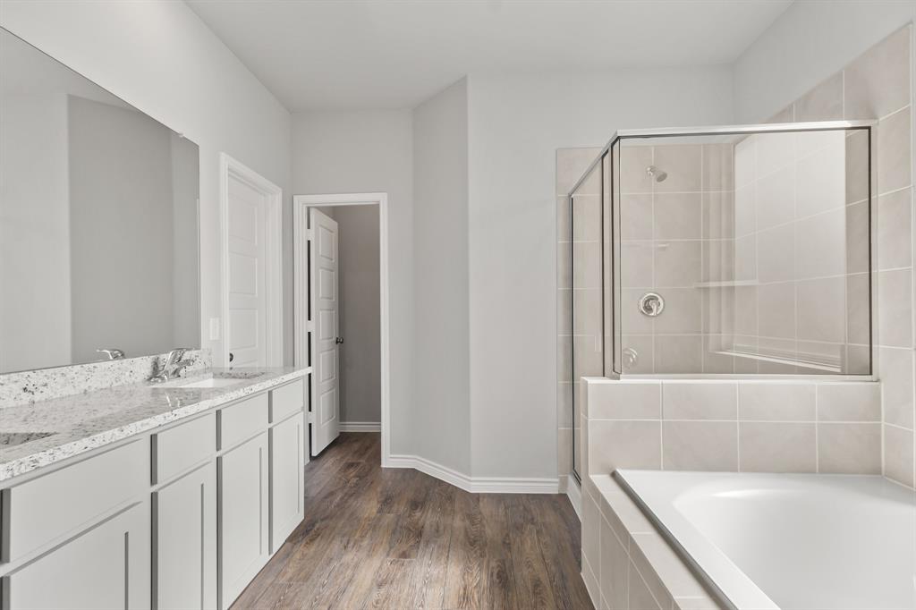 6909 Cattle Car Way Crowley, TX 76036 - Photo 8 of 24 a bathroom with a granite countertop sink a toilet and shower