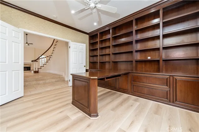 a view of a kitchen with kitchen island a sink a counter top space and cabinets