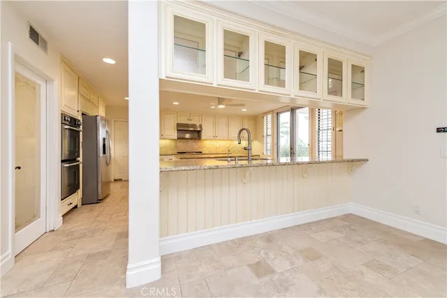 a kitchen with stainless steel appliances granite countertop a stove a sink and a refrigerator