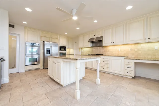 a kitchen with cabinets and white stainless steel appliances