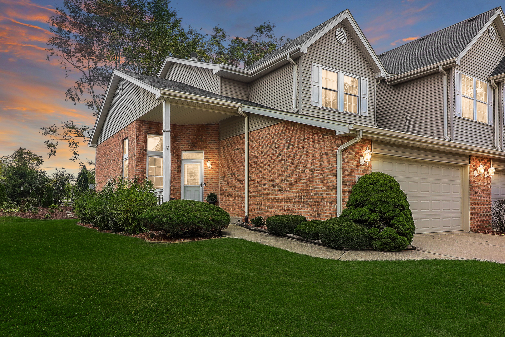 a front view of a house with a garden