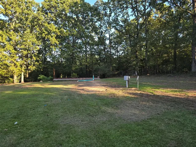 a view of a chair and table in backyard of the house