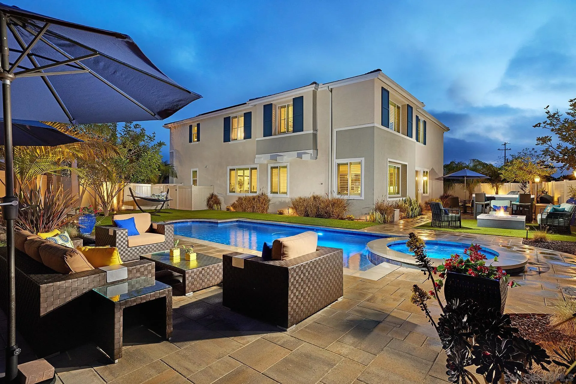 a front view of a house with swimming pool having outdoor seating