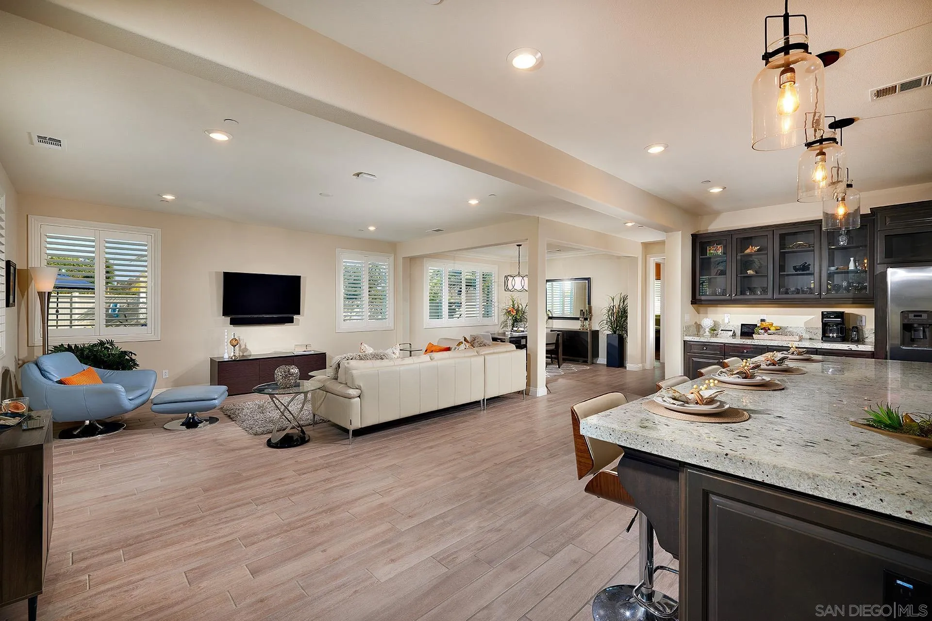1179 Tesoro Place Vista, CA 92081 - Photo 13 of 49 a living room with furniture kitchen view and a wooden floor