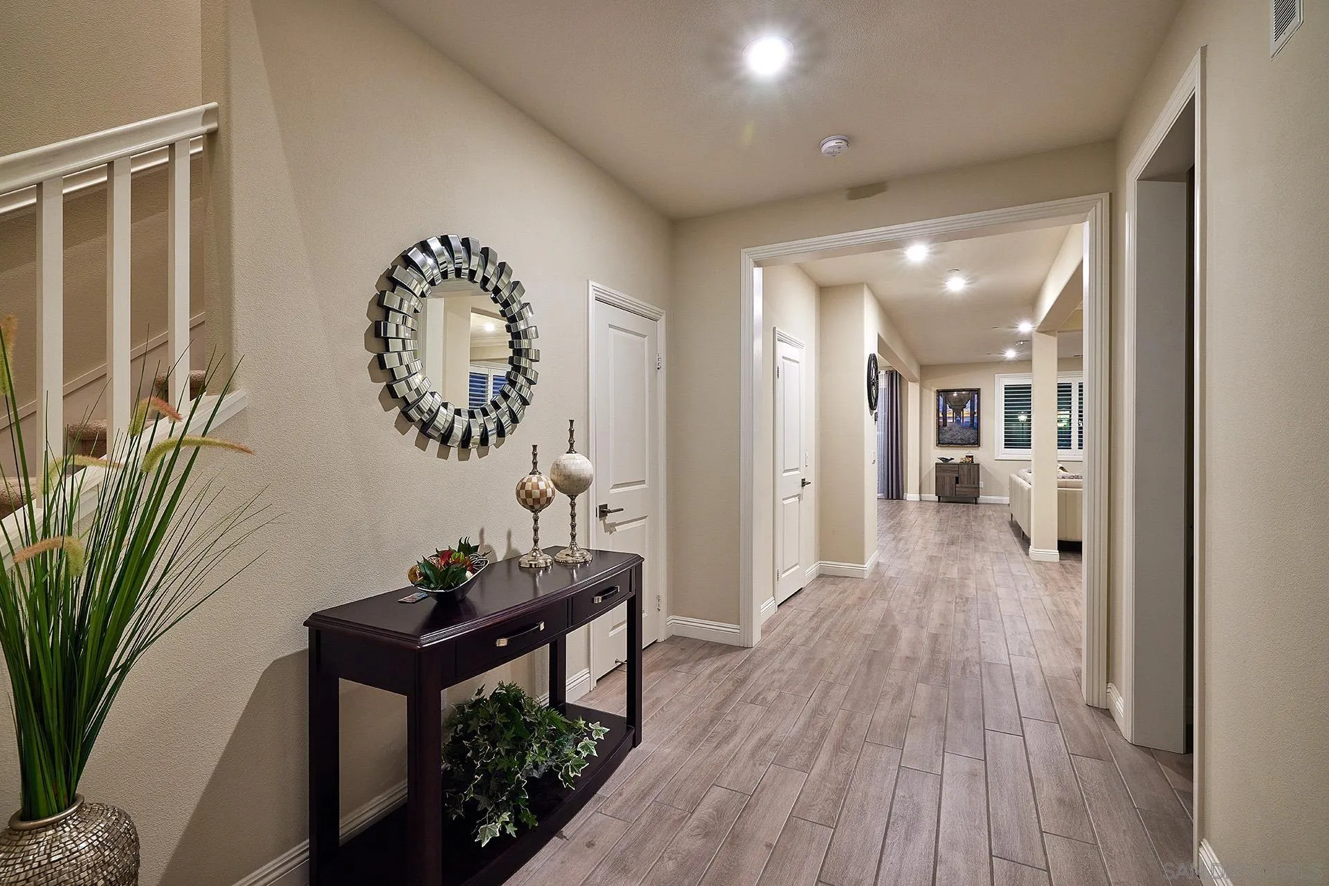 1179 Tesoro Place Vista, CA 92081 - Photo 17 of 49 a view of a hallway with wooden floor and a bathroom