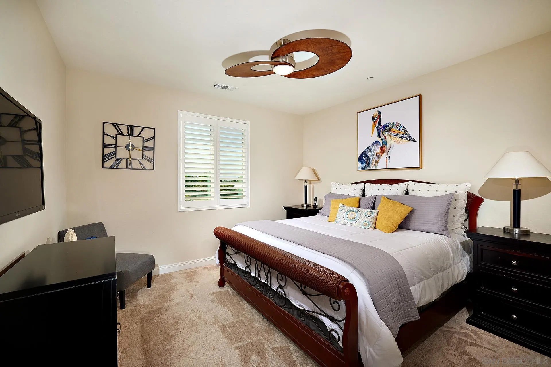 1179 Tesoro Place Vista, CA 92081 - Photo 19 of 49 a bedroom with a bed and a lamp on dresser