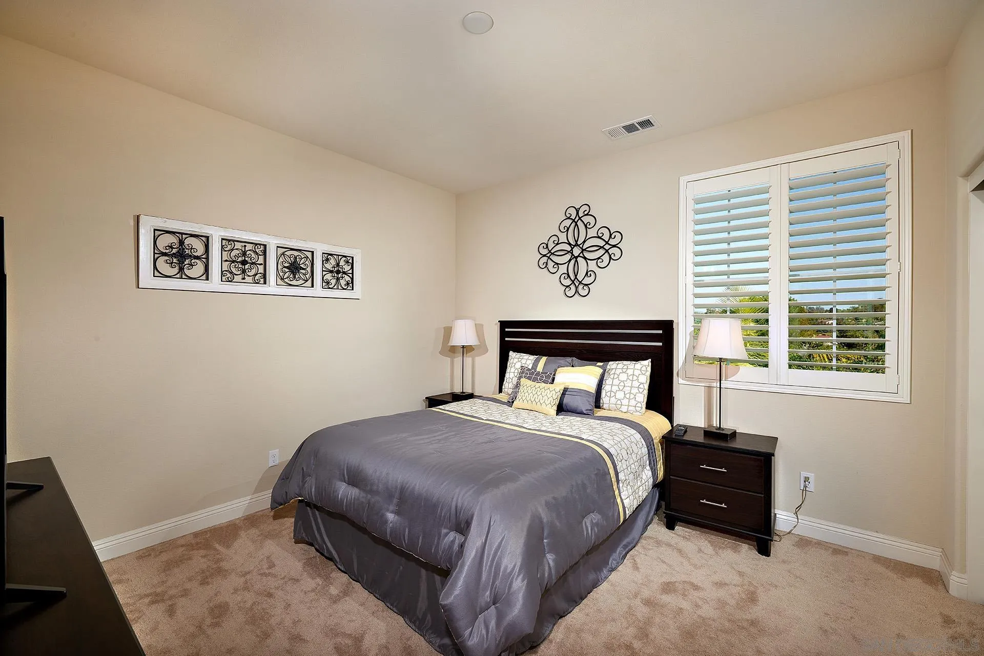 1179 Tesoro Place Vista, CA 92081 - Photo 21 of 49 a bed sitting in a bedroom next to a window