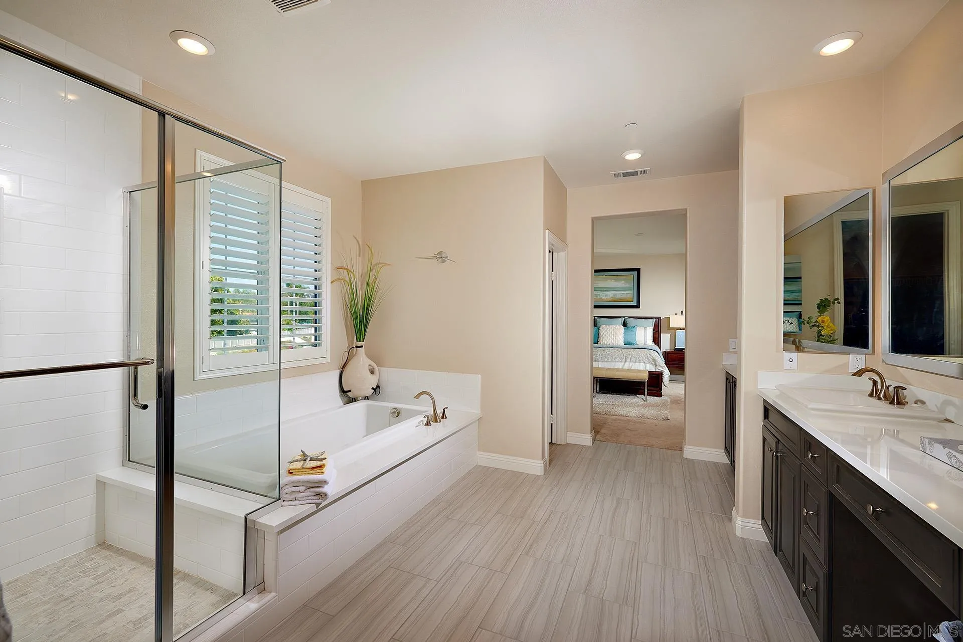 1179 Tesoro Place Vista, CA 92081 - Photo 27 of 49 a spacious bathroom with a double vanity sink a mirror and a bathtub