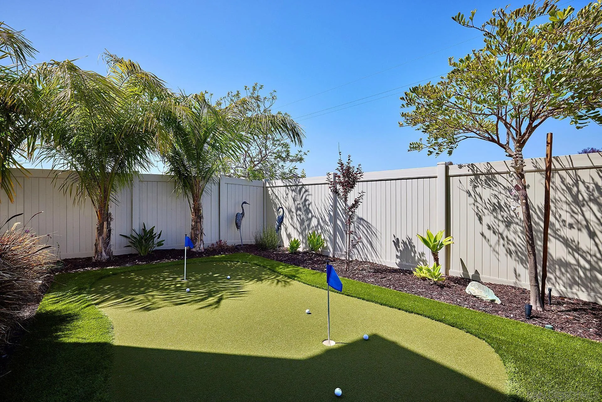 1179 Tesoro Place Vista, CA 92081 - Photo 37 of 49 a view of a backyard with a table and chairs and a barbeque