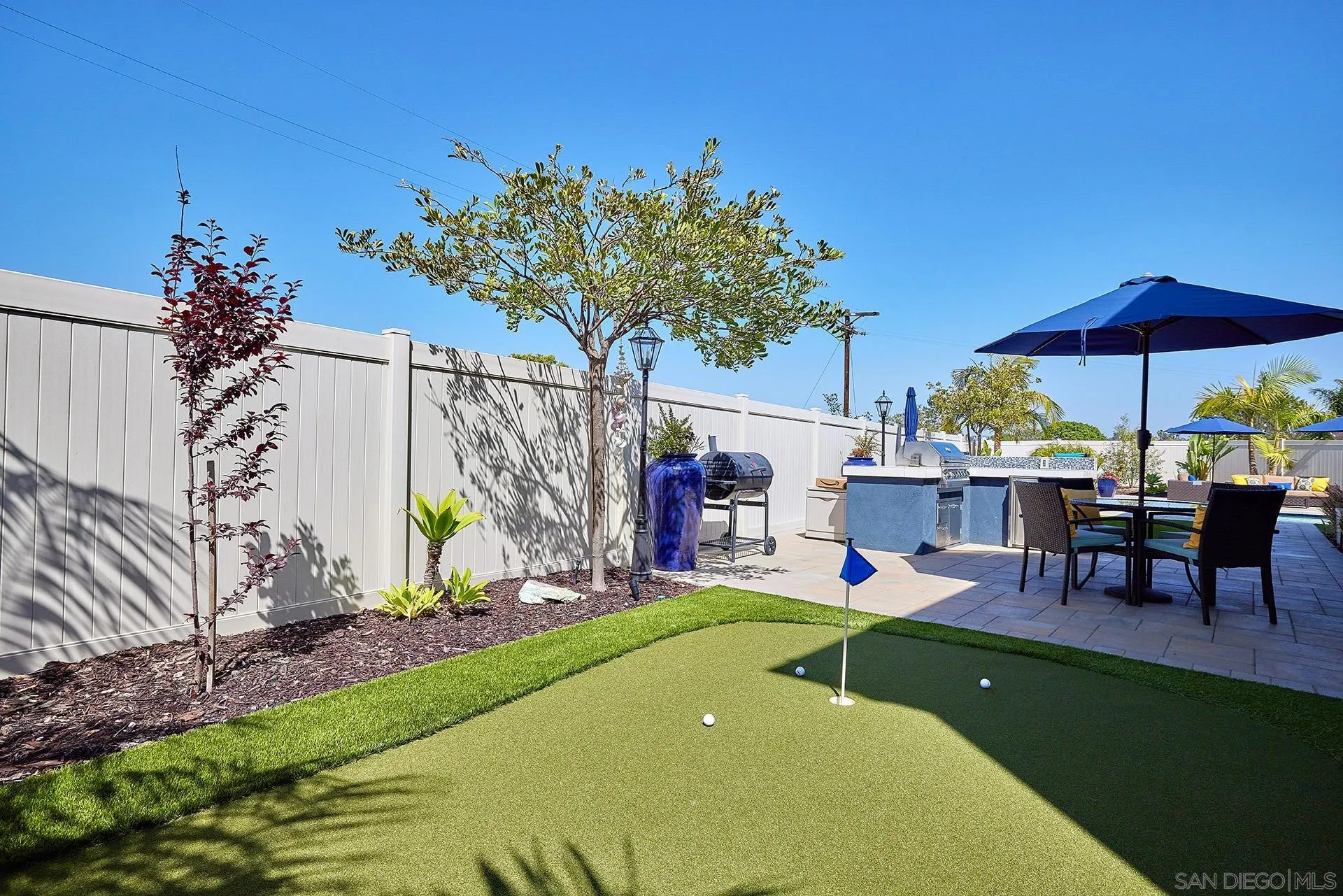 1179 Tesoro Place Vista, CA 92081 - Photo 39 of 49 a view of a chairs and table under an umbrella