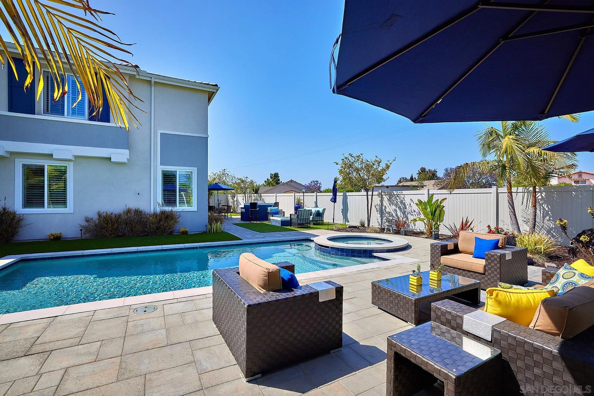 1179 Tesoro Place Vista, CA 92081 - Photo 44 of 49 a view of a patio with couches table and chairs under an umbrella