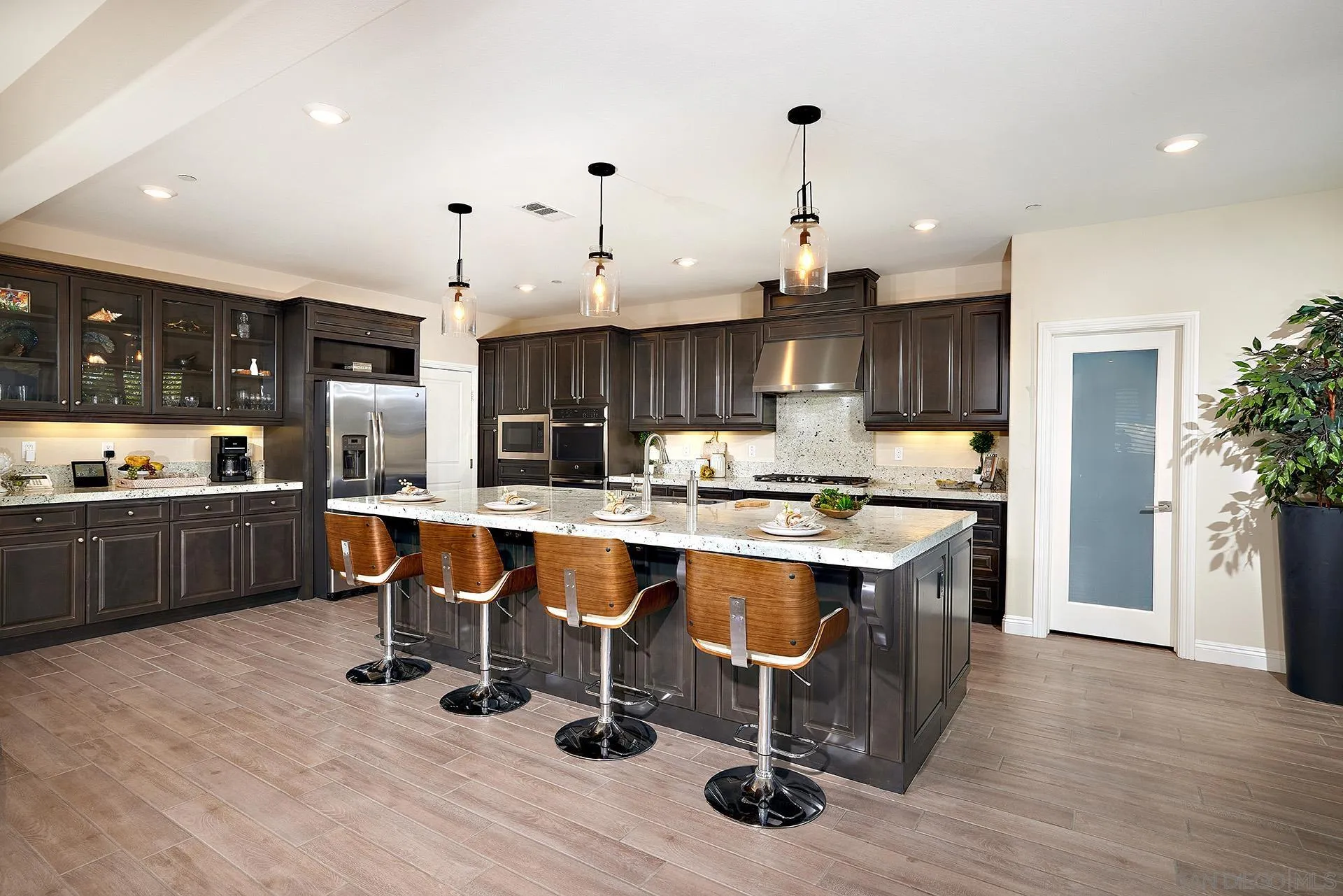 1179 Tesoro Place Vista, CA 92081 - Photo 7 of 49 a large kitchen with a table and chairs