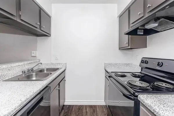 a kitchen with stainless steel appliances granite countertop a sink stove and cabinets