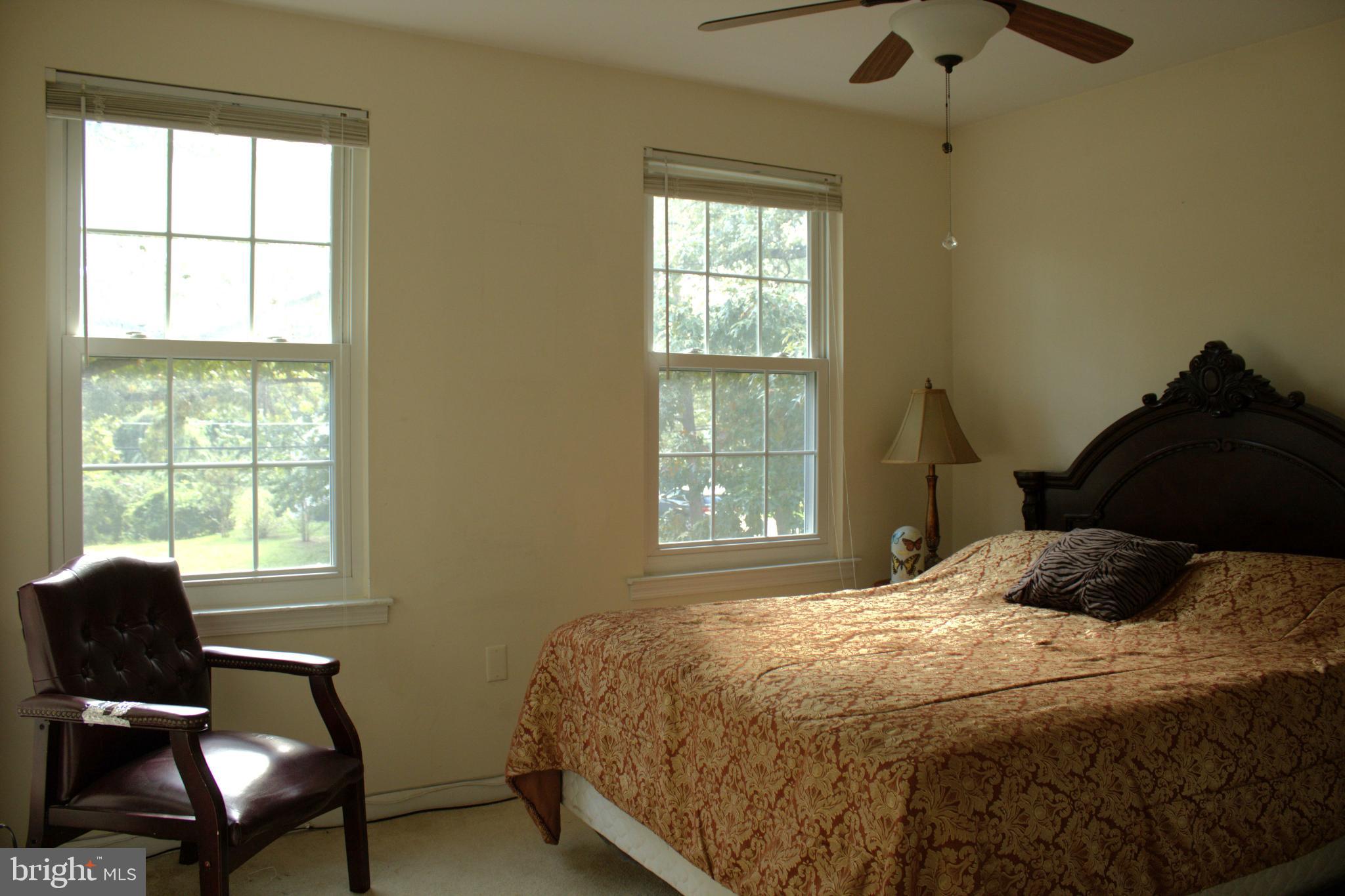 3910 Oaklawn Road Fort Washington, MD 20744 - Photo 13 of 17 a bedroom with a bed window and chair