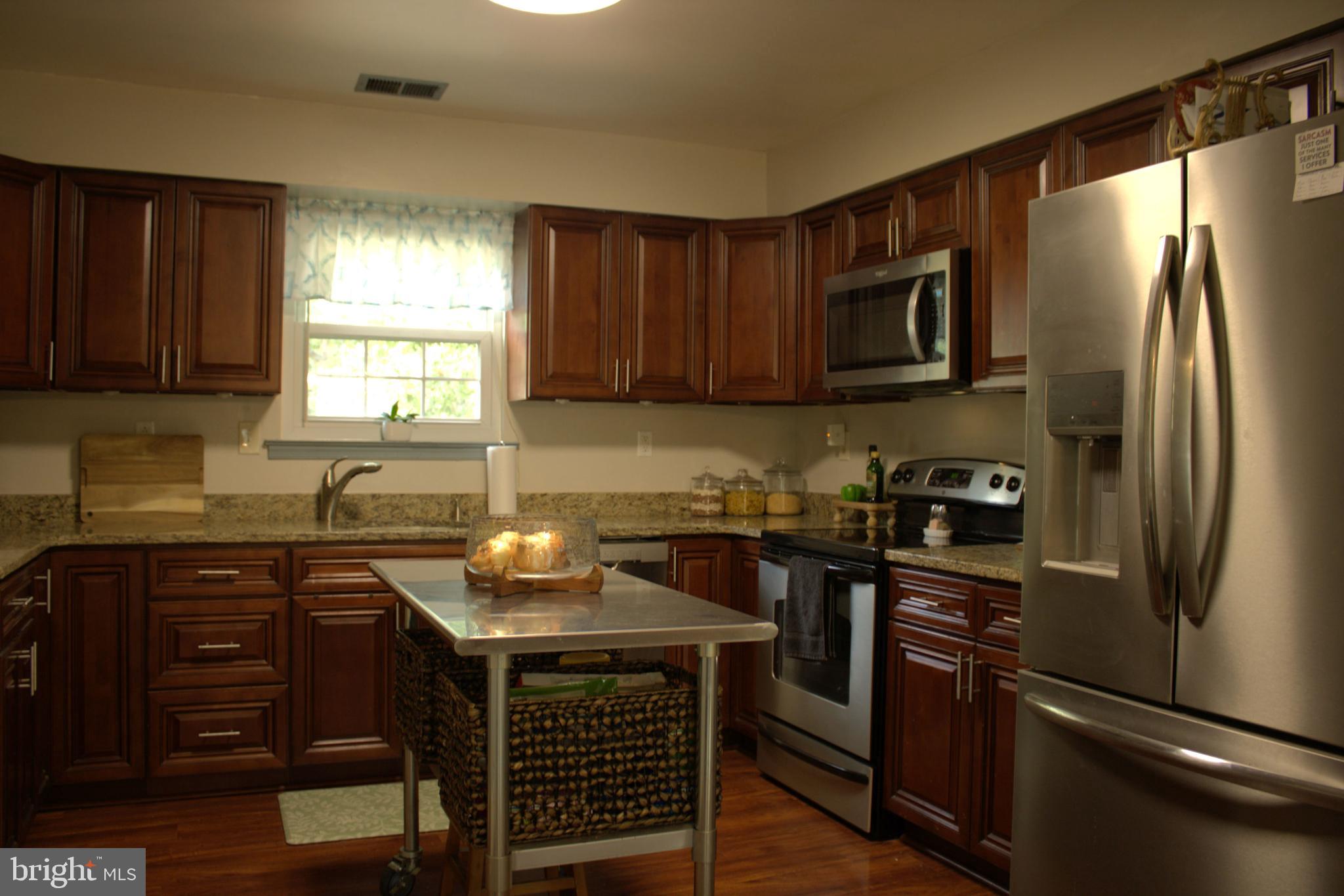 3910 Oaklawn Road Fort Washington, MD 20744 - Photo 6 of 17 a kitchen with stainless steel appliances granite countertop a sink stove and refrigerator