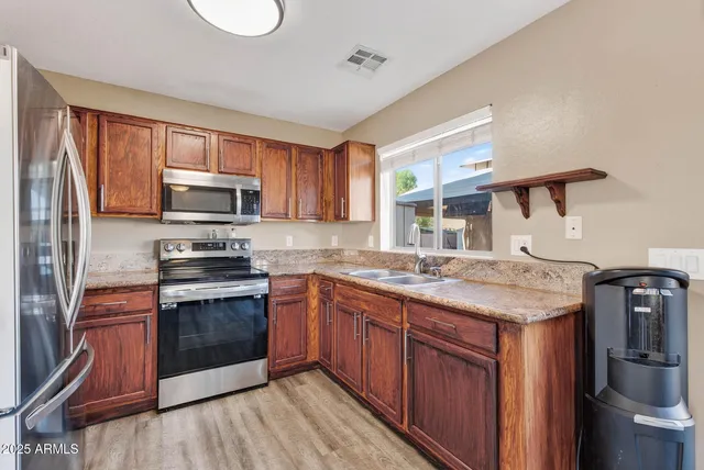 a kitchen with a sink and a wooden cabinets