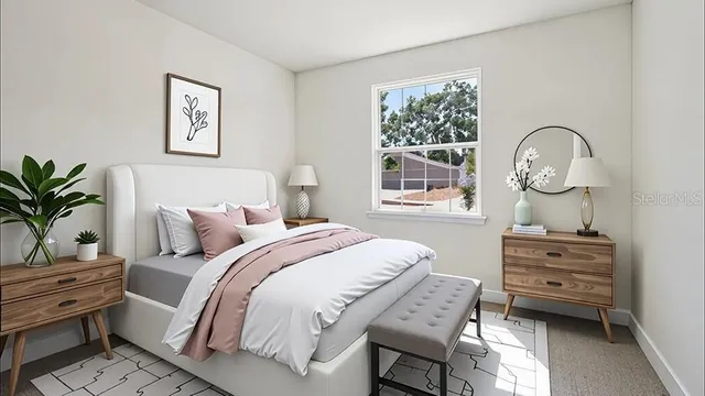 a bedroom with a bed window and dresser