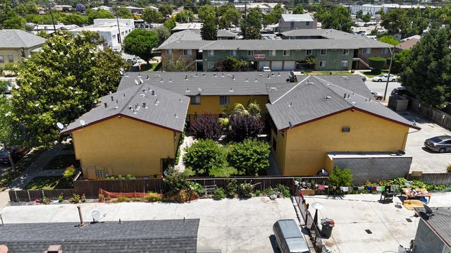 an aerial view of a house with garden space and street view