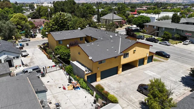 an aerial view of a house with swimming pool and mountains