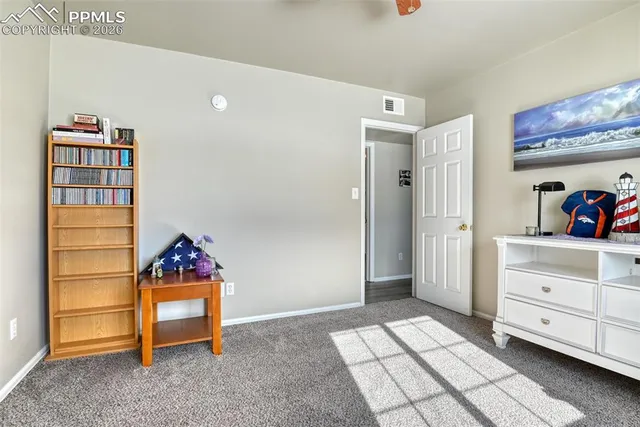 a room with a baby crib and a dresser
