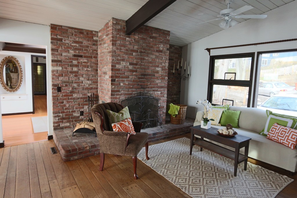 19 Neptune Road Marblehead, MA 01945 - Photo 7 of 16 a living room with furniture and a fireplace