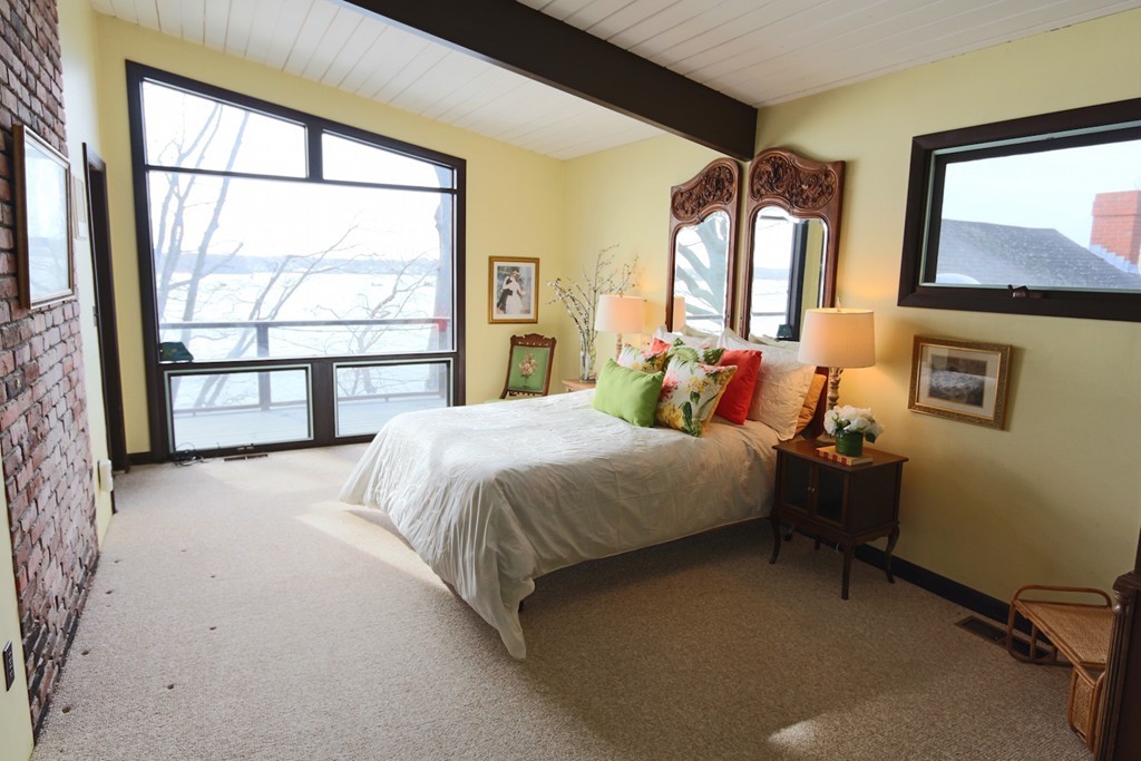19 Neptune Road Marblehead, MA 01945 - Photo 10 of 16 a bed sitting in a bedroom next to a window