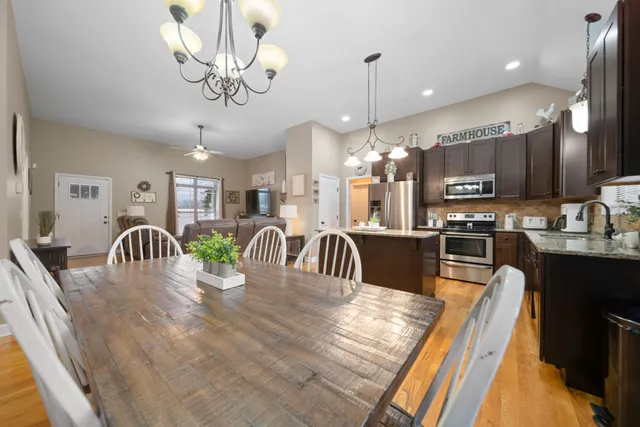 a kitchen with a sink a counter space dining table and a chandelier
