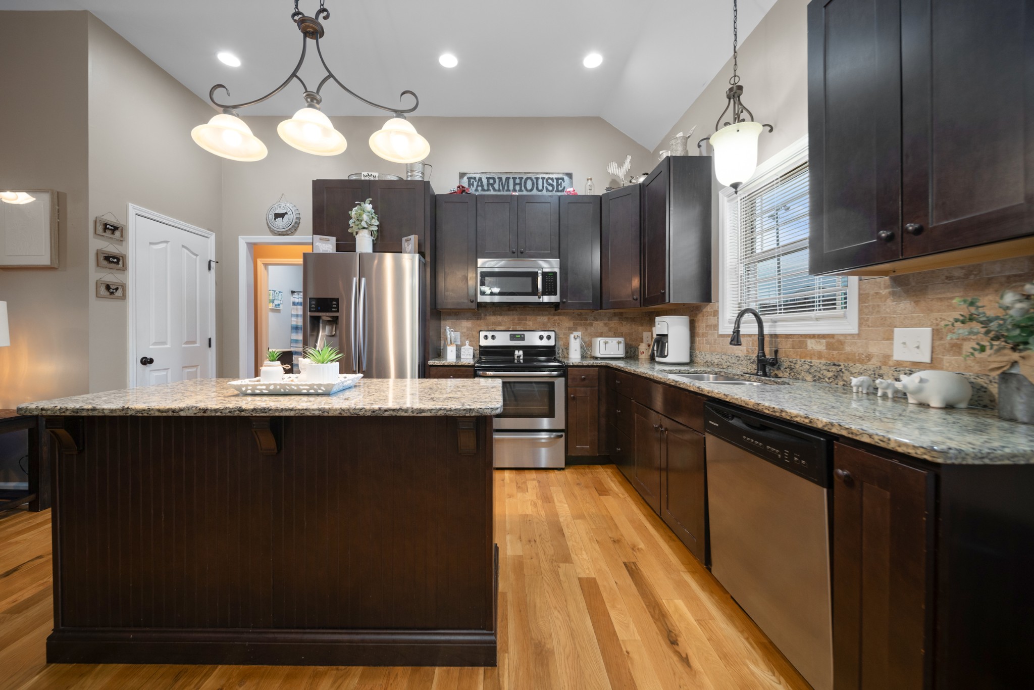 1934 Hygeia Road Greenbrier, TN 37073 - Photo 17 of 36 a kitchen with stainless steel appliances granite countertop a sink a stove top oven a counter space and cabinets