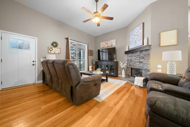 a living room with furniture and a fireplace