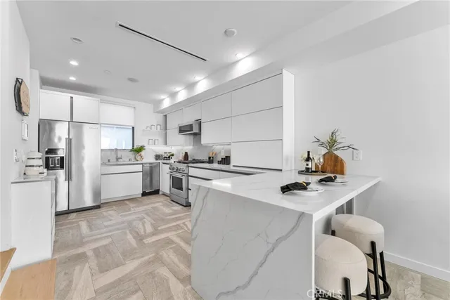 a kitchen with a sink cabinets and stainless steel appliances