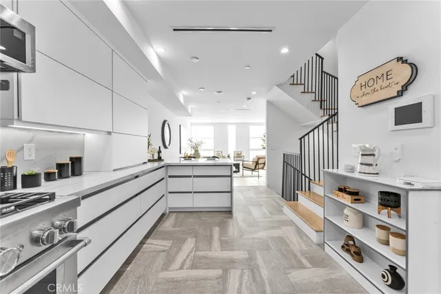 a large white kitchen with cabinets