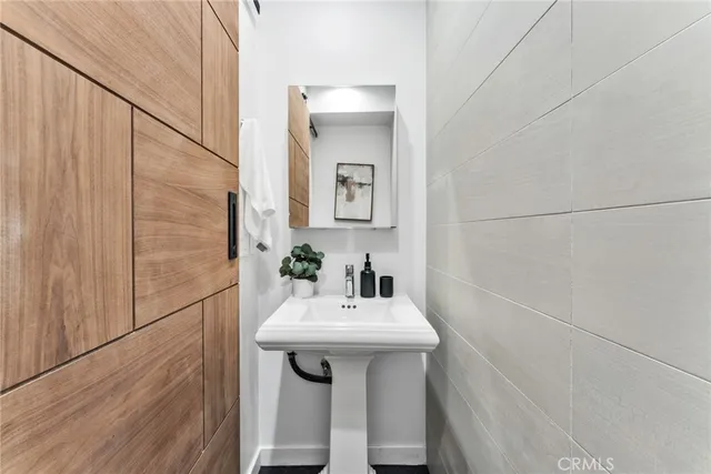 a bathroom with a sink a mirror and vanity