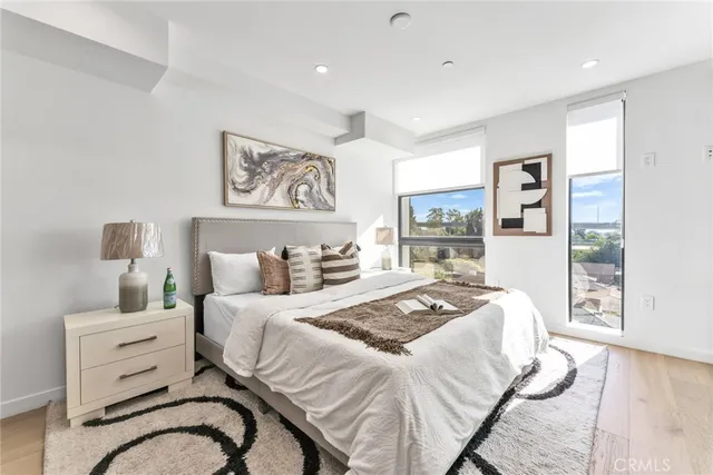 a bedroom with a bed and wooden floor