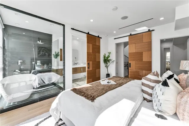 a bedroom with a bed and glass door