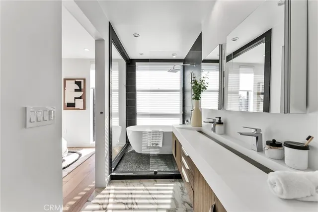 a large white room with a large window and stainless steel appliances