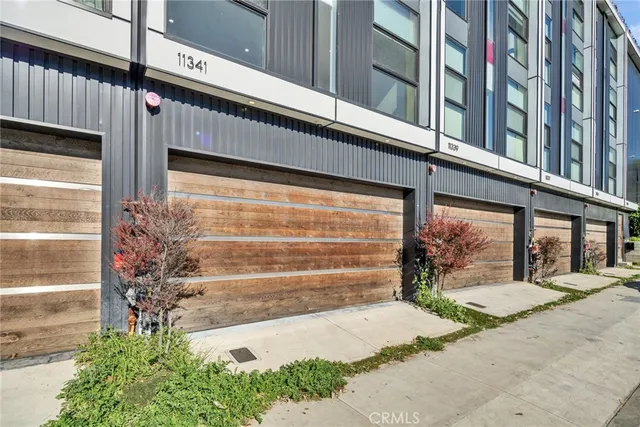 a front view of a building with a garden