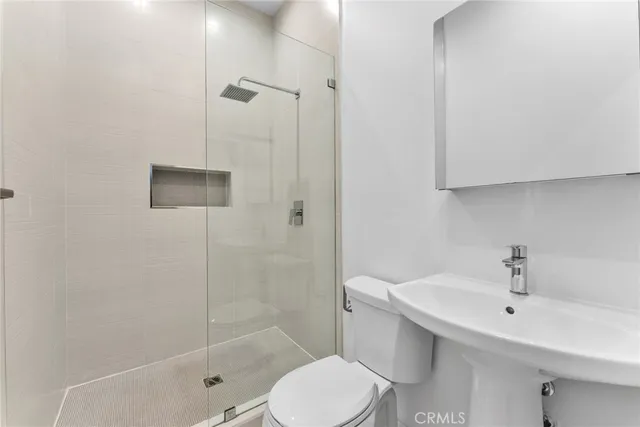 a bathroom with a sink toilet and shower