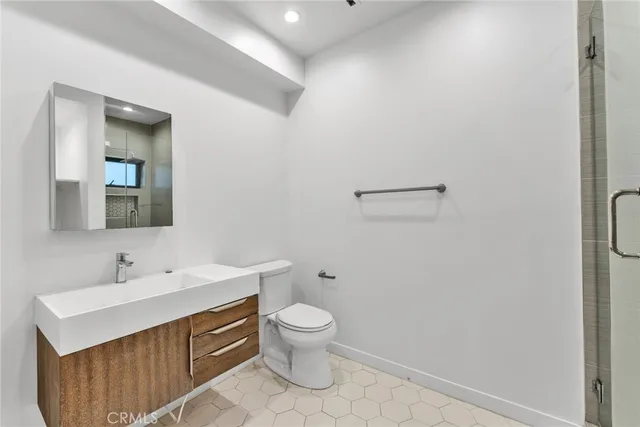 a bathroom with a toilet a sink and mirror