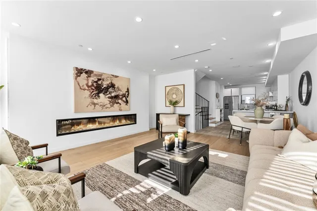 a living room with furniture and paintings on the wall