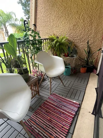 a view of a chairs and table in the patio