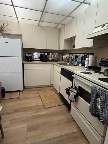 a kitchen with a sink a stove and cabinets