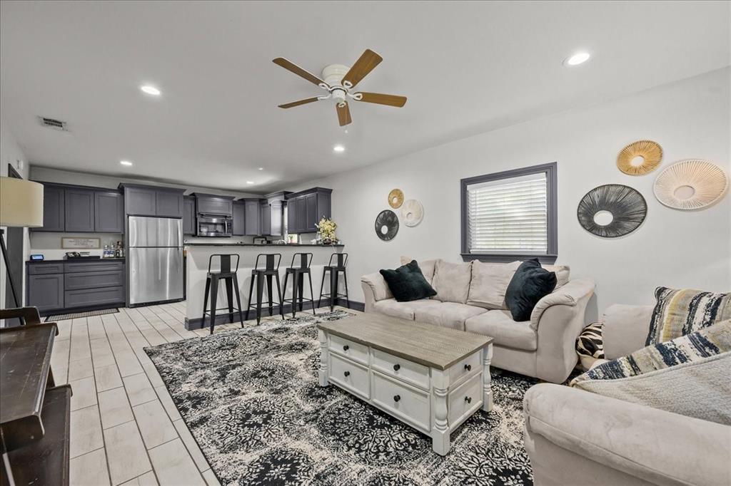 682 Utah Street China Spring, TX 76633 - Photo 1 of 1 View from the living room into the kitchen, featuring recessed lighting, ceiling fan, and light wood-style tile floors
