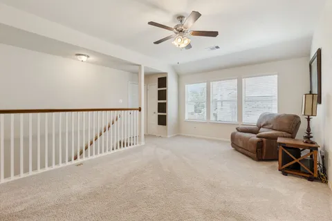 a en suite bathroom with a granite countertop sink a mirror and shower