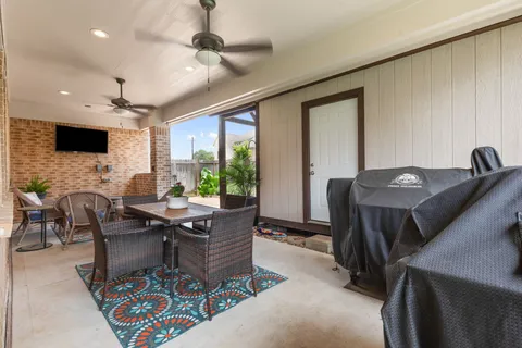 a dining room with furniture a chandelier and wooden floor