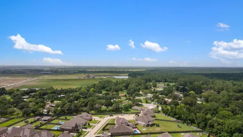 an aerial view of a city with lots of residential buildings ocean and mountain view in back